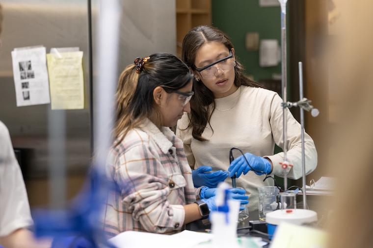 Washington College students in a lab using tools. 